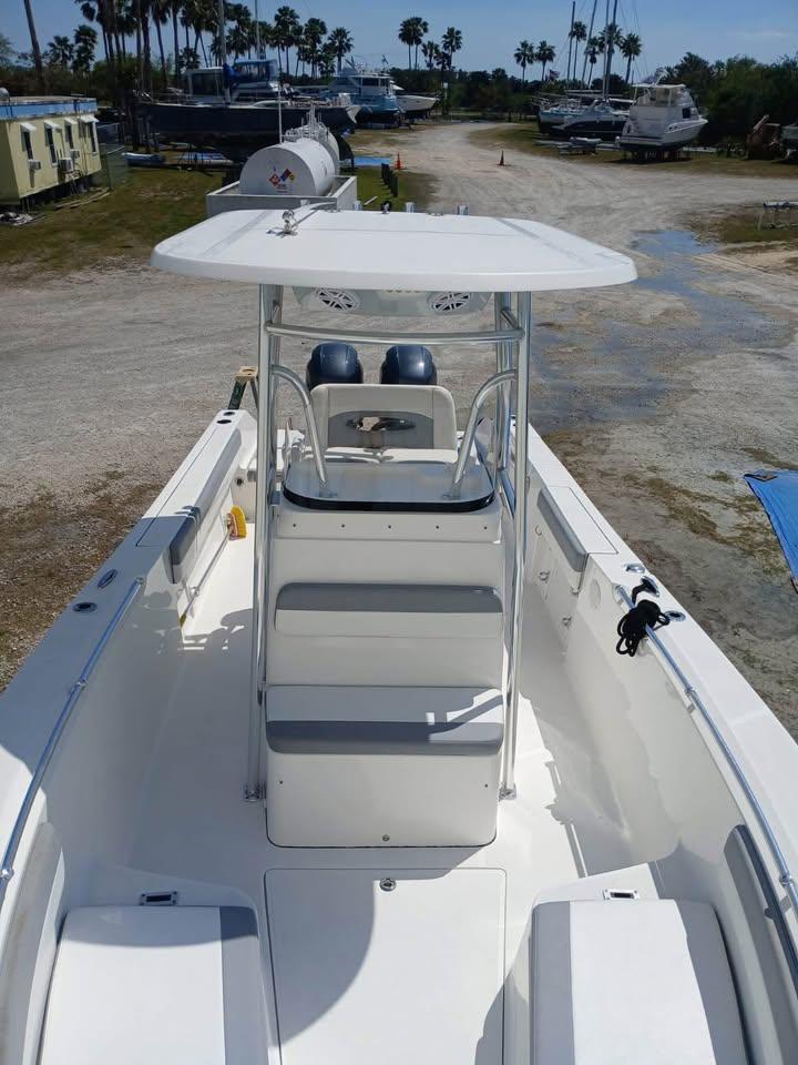 2018 Release 232 RX Center Console boat with T-top, docked outdoors.
