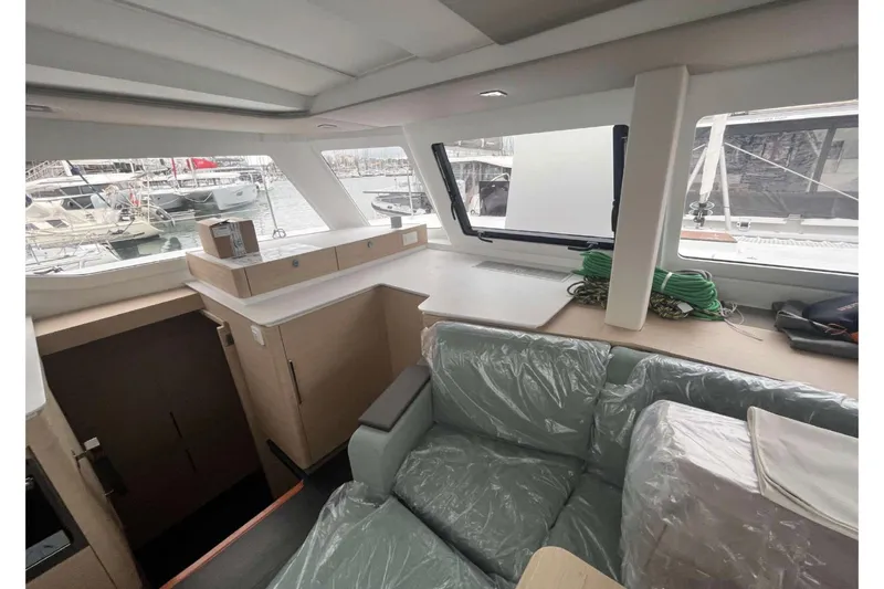 Fonn Taistil Domhain Yacht Photos Pics Interior of 2025 Fountaine Pajot 41 yacht with modern seating and large windows.
