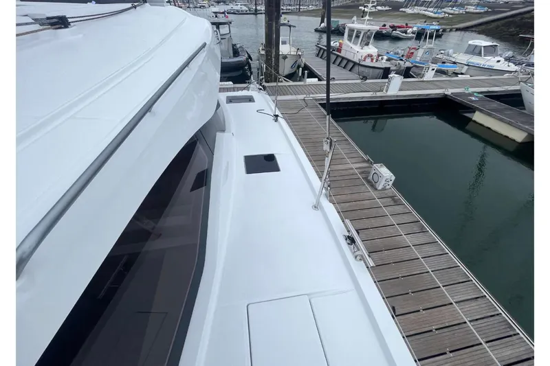 Fonn Taistil Domhain Yacht Photos Pics 2025 Fountaine Pajot 41 yacht docked at marina, showcasing sleek deck design.