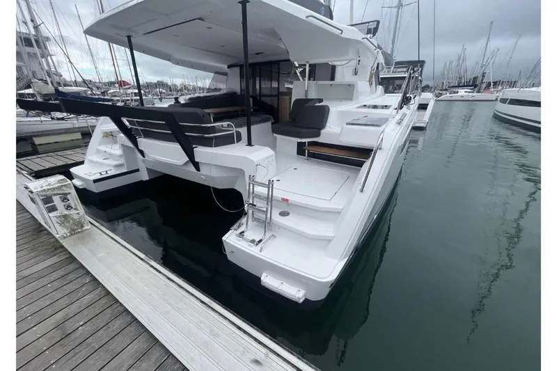 Fonn Taistil Domhain Yacht Photos Pics 2025 Fountaine Pajot 41 catamaran docked at marina, showcasing sleek design and spacious deck.