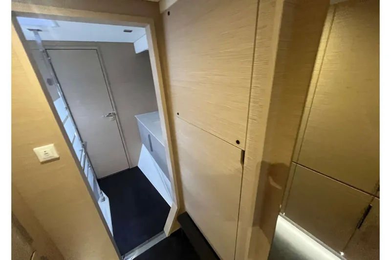 Fonn Taistil Domhain Yacht Photos Pics Interior hallway of 2025 Fountaine Pajot 41 yacht, featuring modern design and wood finishes.