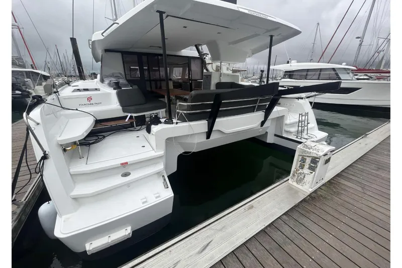 Fonn Taistil Domhain Yacht Photos Pics 2025 Fountaine Pajot 41 catamaran docked at marina, showcasing sleek design and spacious deck.