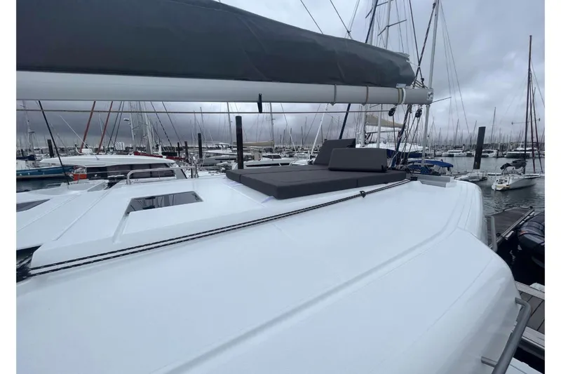 Fonn Taistil Domhain Yacht Photos Pics 2025 Fountaine Pajot 41 catamaran docked in a marina under cloudy skies.