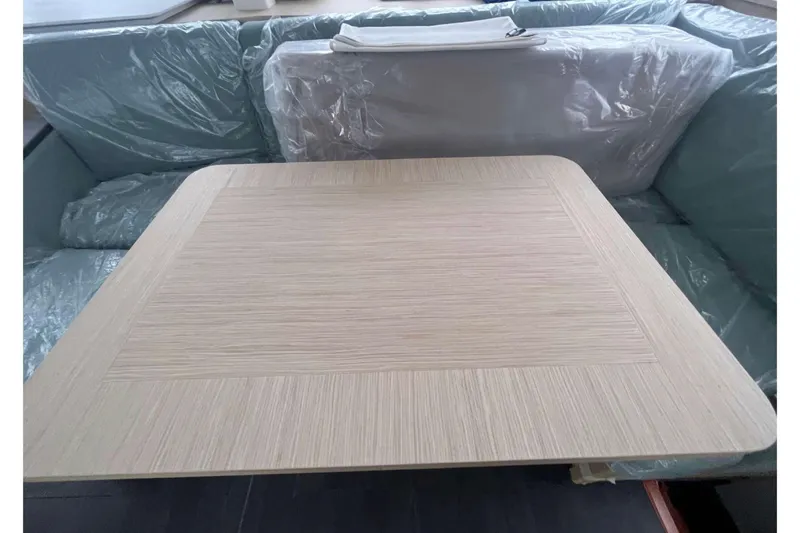 Fonn Taistil Domhain Yacht Photos Pics Modern interior of 2025 Fountaine Pajot 41 yacht with sleek wooden table.