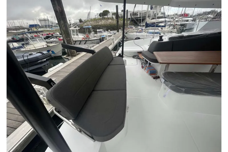 Fonn Taistil Domhain Yacht Photos Pics 2025 Fountaine Pajot 41 yacht interior with seating and table at marina.