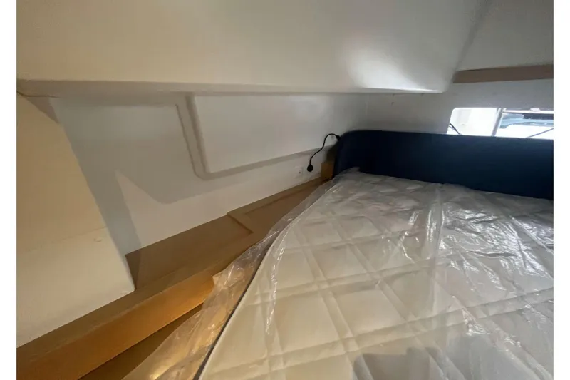 Fonn Taistil Domhain Yacht Photos Pics Interior cabin of 2025 Fountaine Pajot 41 catamaran with bed and window view.