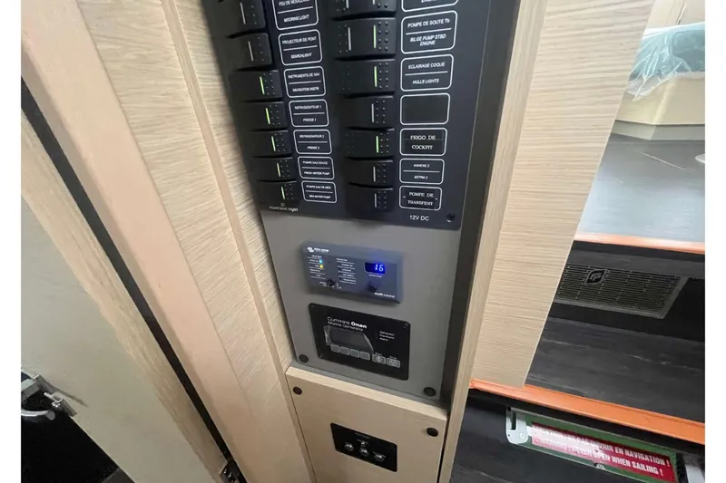 Fonn Taistil Domhain Yacht Photos Pics Electrical control panel inside 2025 Fountaine Pajot 41 yacht, featuring various switches and displays.