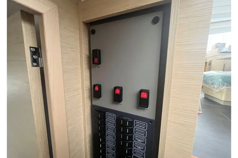 Fonn Taistil Domhain Yacht Photos Pics Electrical panel inside 2025 Fountaine Pajot 41 yacht, featuring switches and labels.