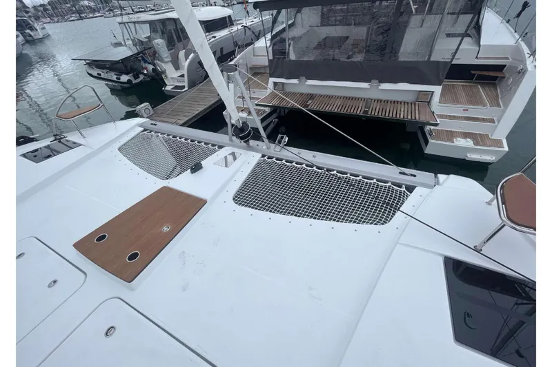 Fonn Taistil Domhain Yacht Photos Pics 2025 Fountaine Pajot 41 catamaran docked, showcasing deck and netting details.