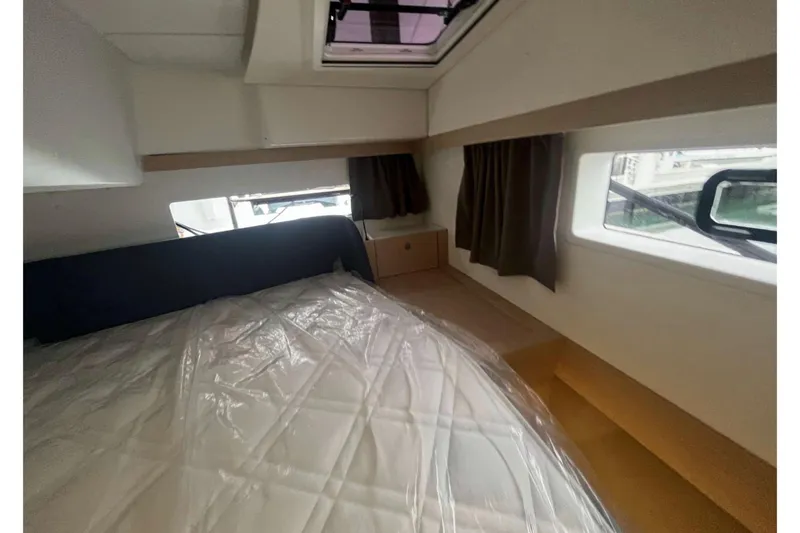 Fonn Taistil Domhain Yacht Photos Pics Interior cabin of 2025 Fountaine Pajot 41 yacht with bed and windows.