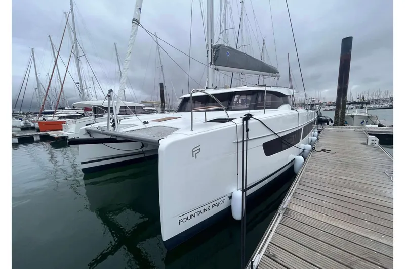 Fonn Taistil Domhain Yacht Photos Pics 2025 Fountaine Pajot 41 catamaran docked at marina under cloudy skies.