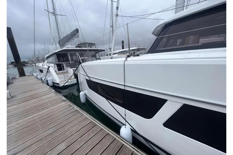 Fonn Taistil Domhain Yacht Photos Pics 2025 Fountaine Pajot 41 catamaran docked at marina on a cloudy day.