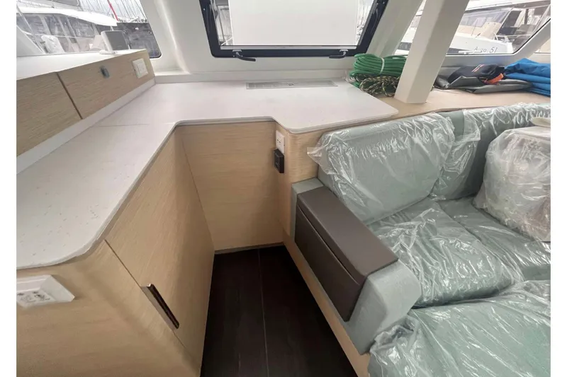 Fonn Taistil Domhain Yacht Photos Pics Modern interior of 2025 Fountaine Pajot 41 yacht with sleek cabinetry and cushioned seating.