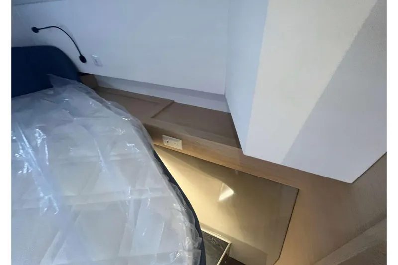 Fonn Taistil Domhain Yacht Photos Pics Interior cabin of 2025 Fountaine Pajot 41 yacht, featuring modern design and bedding.