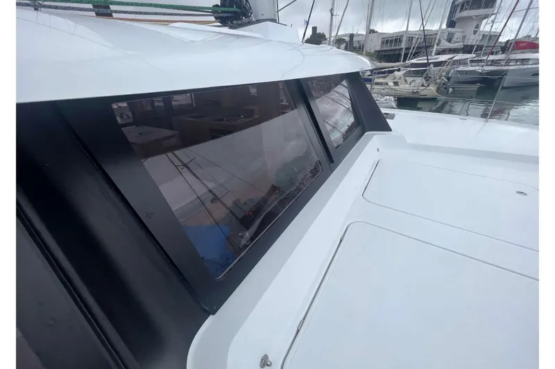 Fonn Taistil Domhain Yacht Photos Pics 2025 Fountaine Pajot 41 yacht with sleek windows docked at a marina.