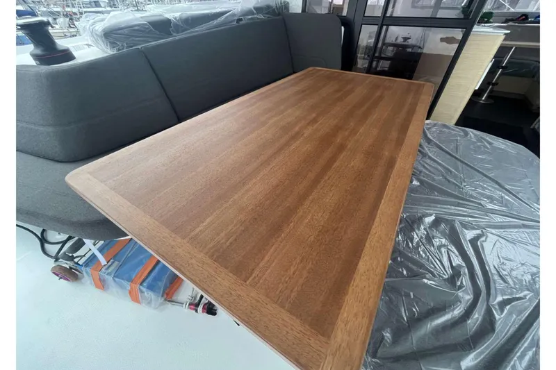 Fonn Taistil Domhain Yacht Photos Pics Wooden table and seating area on 2025 Fountaine Pajot 41 yacht interior.