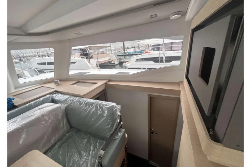 Fonn Taistil Domhain Yacht Photos Pics Interior view of 2025 Fountaine Pajot 41 yacht, showcasing modern design and marina backdrop.