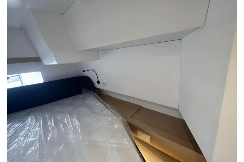 Fonn Taistil Domhain Yacht Photos Pics Interior cabin of 2025 Fountaine Pajot 41 yacht, featuring a bed and reading light.