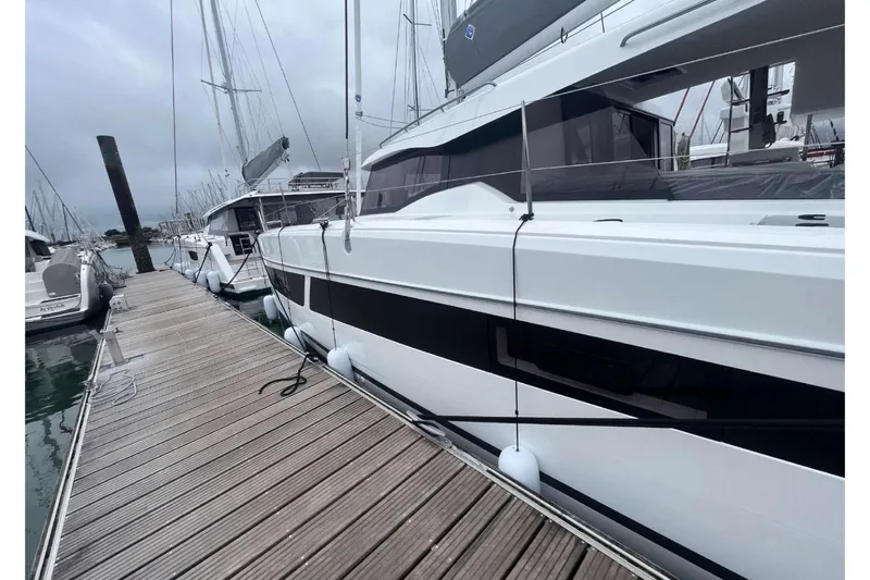 Fonn Taistil Domhain Yacht Photos Pics 2025 Fountaine Pajot 41 catamaran docked at marina, sleek design, overcast sky.