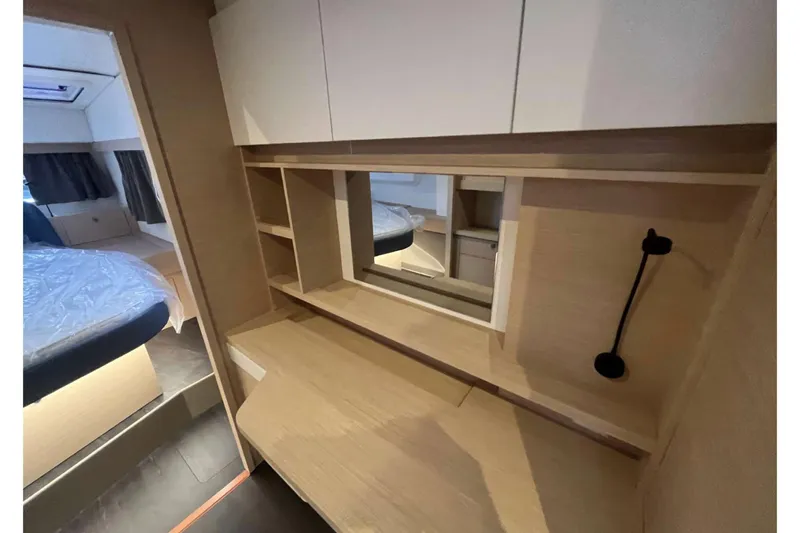 Fonn Taistil Domhain Yacht Photos Pics Interior of 2025 Fountaine Pajot 41 yacht with modern wood finish and storage.