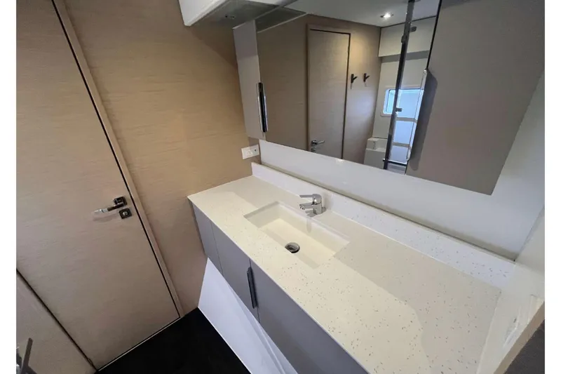 Fonn Taistil Domhain Yacht Photos Pics Modern bathroom interior of 2025 Fountaine Pajot 41 yacht with sleek sink and mirror.