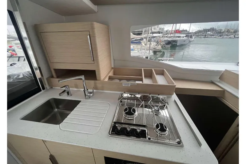 Fonn Taistil Domhain Yacht Photos Pics Modern kitchen interior of 2025 Fountaine Pajot 41 yacht with stove and sink.