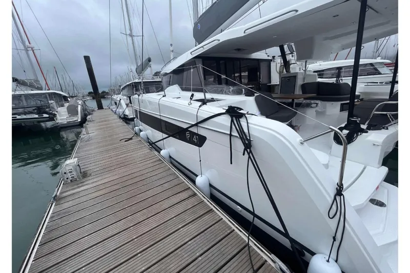 Fonn Taistil Domhain Yacht Photos Pics 2025 Fountaine Pajot 41 yacht docked at marina, showcasing sleek design and modern features.