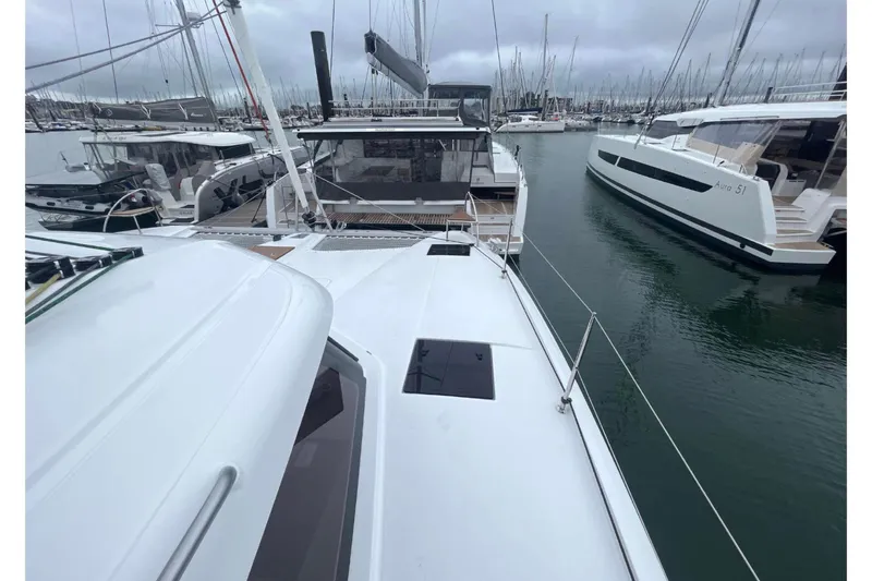 Fonn Taistil Domhain Yacht Photos Pics 2025 Fountaine Pajot 41 catamaran docked in a marina, surrounded by other boats.