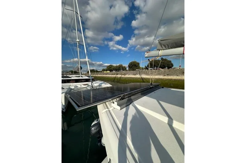 Fonn Taistil Domhain Yacht Photos Pics 2025 Fountaine Pajot 41 catamaran with solar panels under a partly cloudy sky.