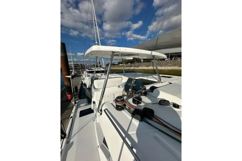 Fonn Taistil Domhain Yacht Photos Pics 2025 Fountaine Pajot 41 catamaran docked, showcasing deck and rigging under a blue sky.