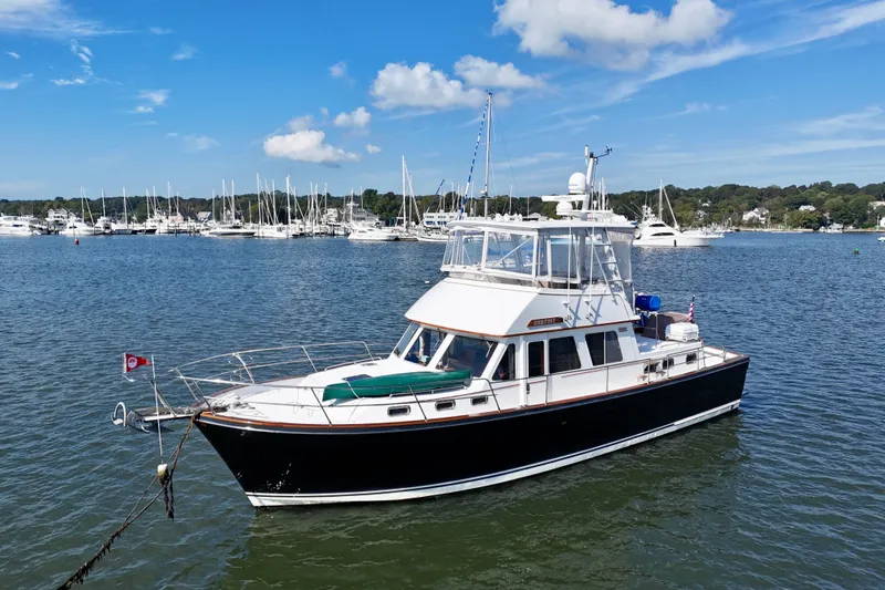 Destiny Yacht Photos Pics 1997 Sabre Sabreline 47 yacht anchored in a scenic marina with sailboats.