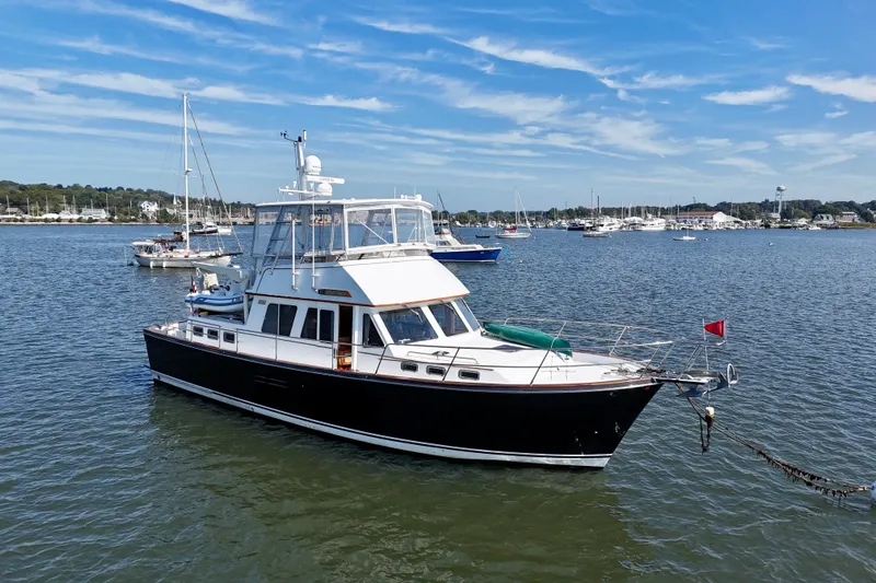 Destiny Yacht Photos Pics 1997 Sabre Sabreline 47 yacht anchored in a scenic harbor with sailboats.