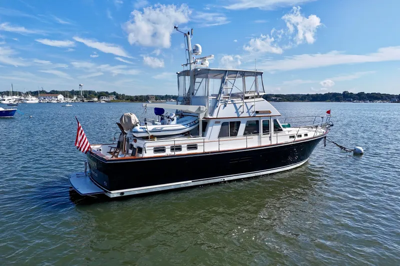 Destiny Yacht Photos Pics 1997 Sabre Sabreline 47 yacht moored on calm water under a clear blue sky.