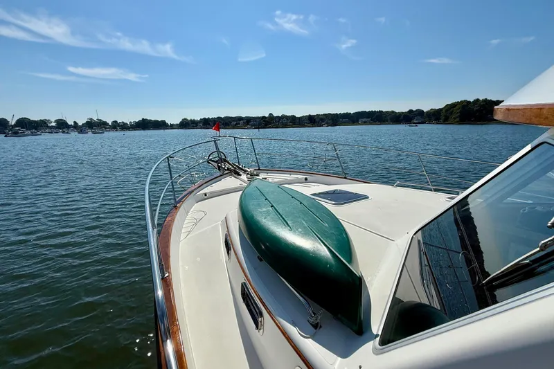 Destiny Yacht Photos Pics 1997 Sabre Sabreline 47 yacht on calm water, featuring a kayak on deck.