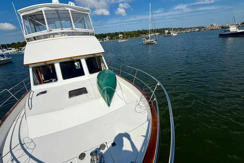 Destiny Yacht Photos Pics 1997 Sabre Sabreline 47 yacht on calm water, clear sky, and nearby boats.