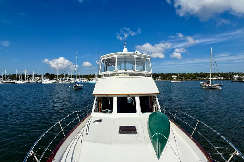 Destiny Yacht Photos Pics 1997 Sabre Sabreline 47 yacht on calm waters, surrounded by sailboats under a clear blue sky.