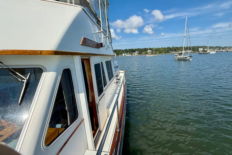Destiny Yacht Photos Pics 1997 Sabre Sabreline 47 yacht on calm water with sailboats in the background.