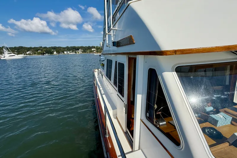 Destiny Yacht Photos Pics 1997 Sabre Sabreline 47 yacht on calm water, showcasing sleek design and scenic backdrop.
