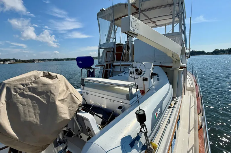 Destiny Yacht Photos Pics 1997 Sabre Sabreline 47 yacht with dinghy on deck, moored on a sunny day.