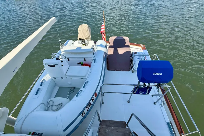 Destiny Yacht Photos Pics 1997 Sabre Sabreline 47 yacht with inflatable boat and Magma grill on deck.