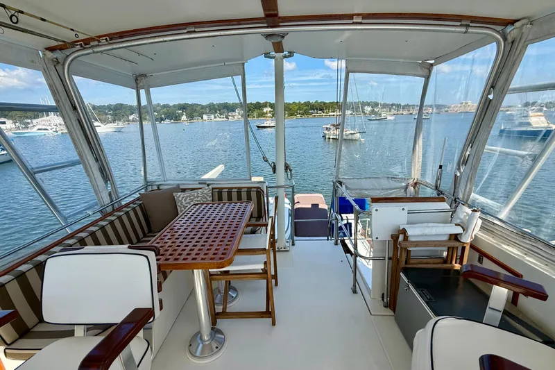 Destiny Yacht Photos Pics 1997 Sabre Sabreline 47 yacht interior with seating area and scenic marina view.