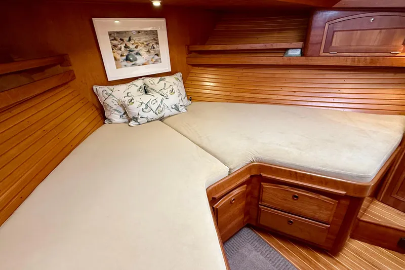 Destiny Yacht Photos Pics Cozy cabin interior of 1997 Sabreline 47 yacht with wooden paneling and comfortable bedding.