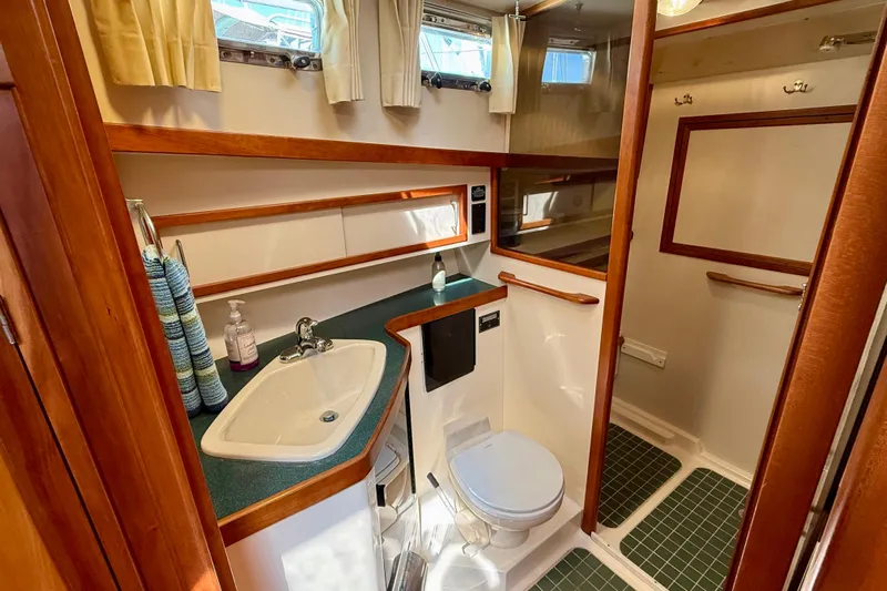 Destiny Yacht Photos Pics Bathroom interior of 1997 Sabre Sabreline 47 yacht with sink, toilet, and wooden accents.