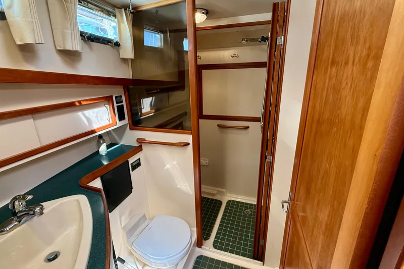 Destiny Yacht Photos Pics Bathroom interior of 1997 Sabreline 47 yacht with sink, toilet, and shower.
