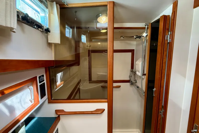 Destiny Yacht Photos Pics Interior of 1997 Sabre Sabreline 47 yacht bathroom with wooden accents and shower.