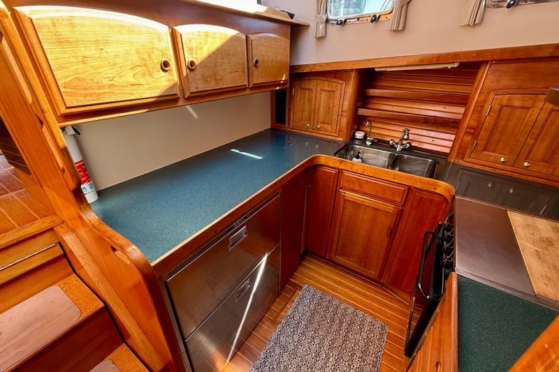 Destiny Yacht Photos Pics 1997 Sabre Sabreline 47 yacht kitchen with wooden cabinetry and modern appliances.