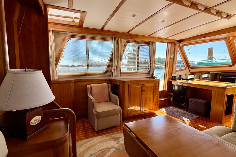 Destiny Yacht Photos Pics Interior of 1997 Sabreline 47 yacht with wooden furnishings and large windows.