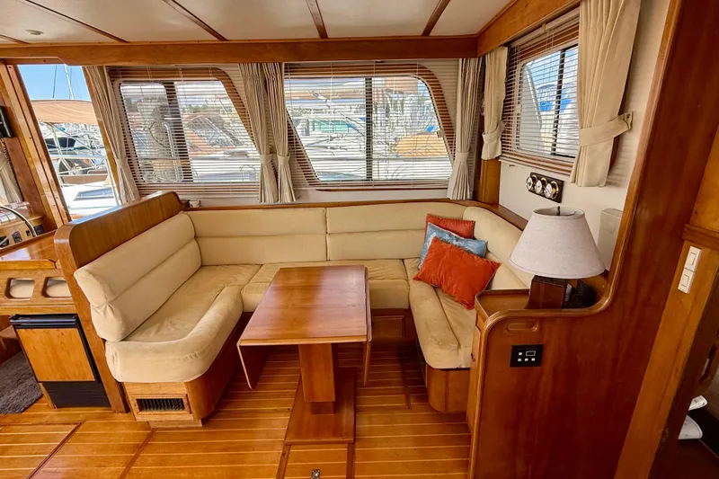 Destiny Yacht Photos Pics Luxurious 1997 Sabreline 47 yacht interior with cozy seating and elegant wood finish.