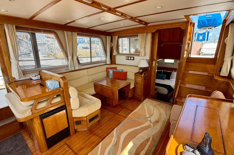 Destiny Yacht Photos Pics Luxurious interior of 1997 Sabreline 47 yacht with wood finishes and cozy seating area.