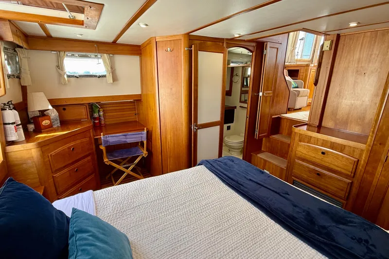 Destiny Yacht Photos Pics Luxurious 1997 Sabreline 47 yacht interior with wooden cabinetry and cozy bedroom.